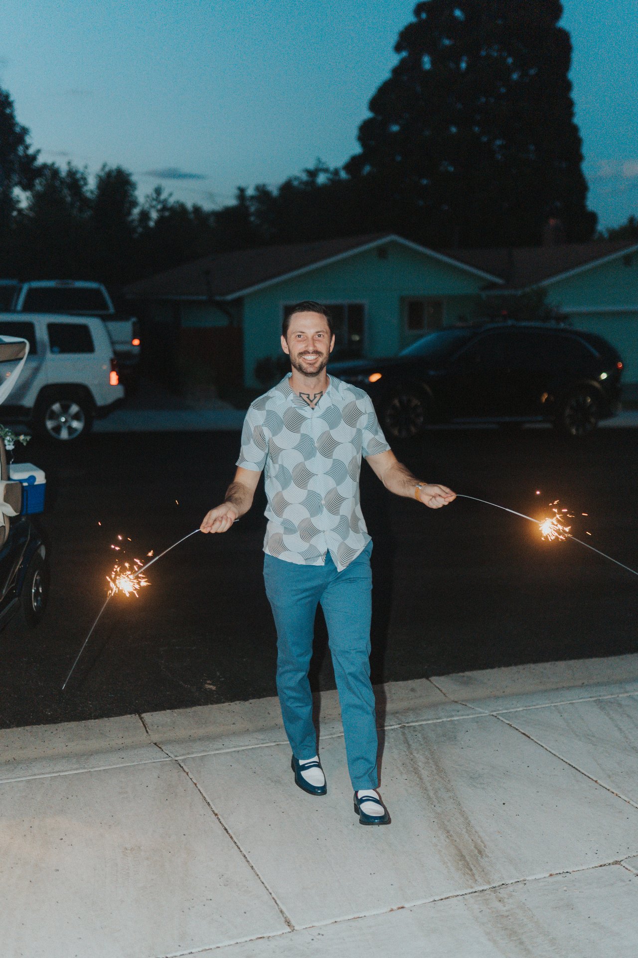 Jeremy smiling with sparklers at the send off