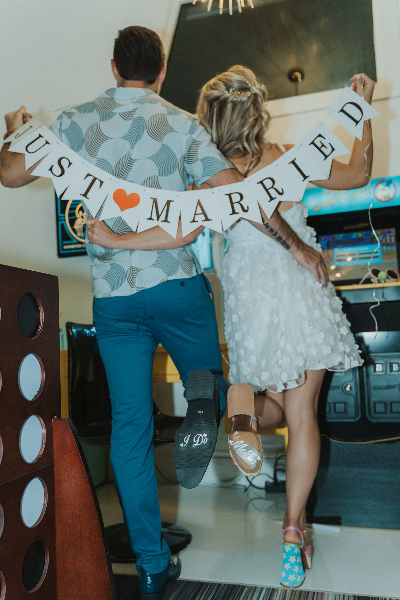 Lexy pops her foot behind the Just Married banner