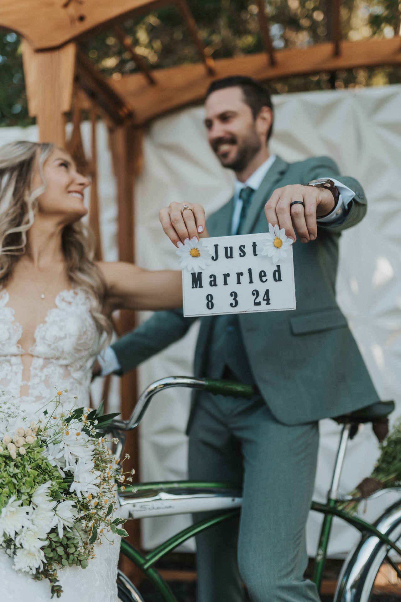 Jeremy holds up the Just Married sign