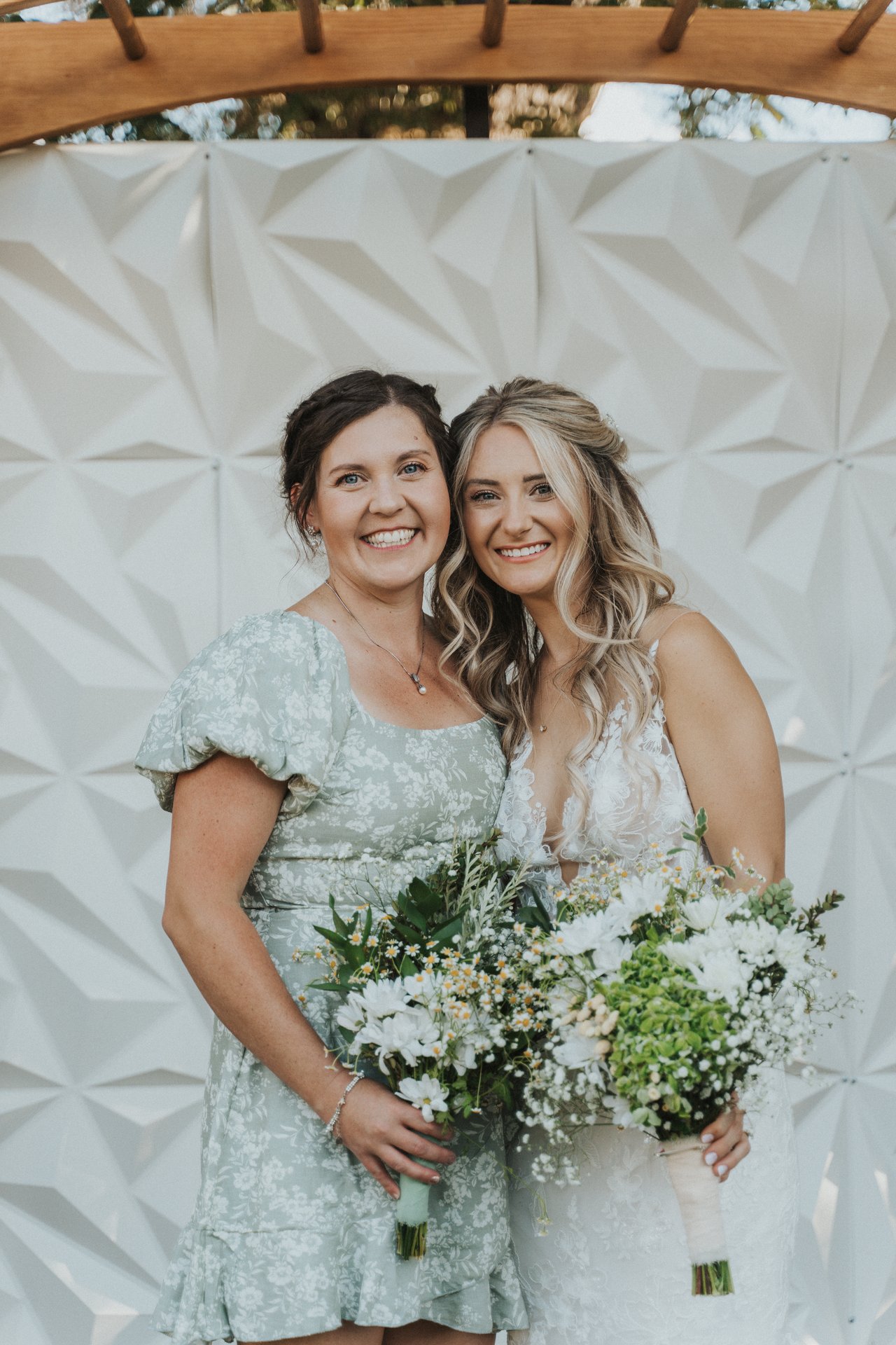 Lexy with a bridesmaid in a floral dress