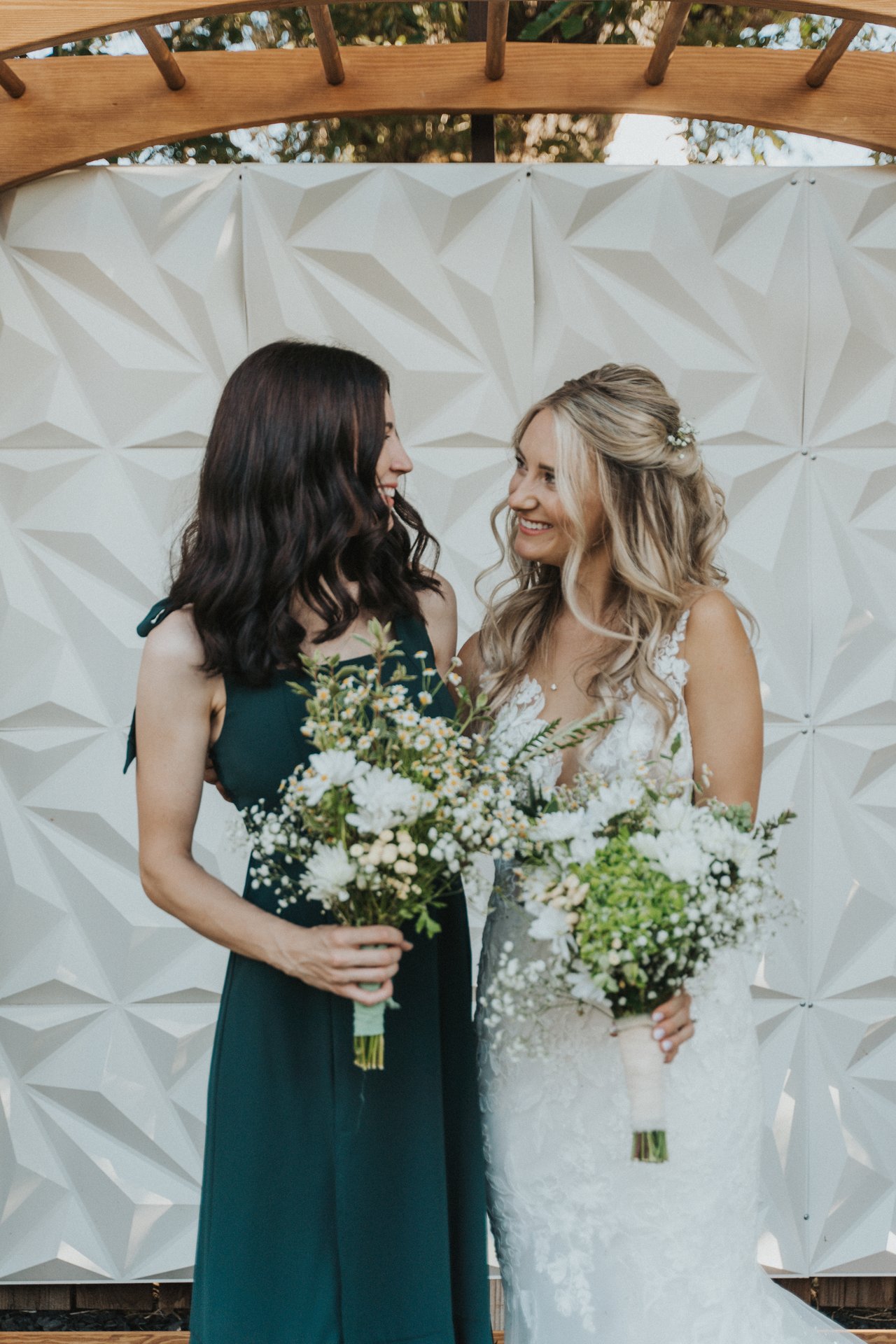 Lexy and a bridesmaid smiling at each other