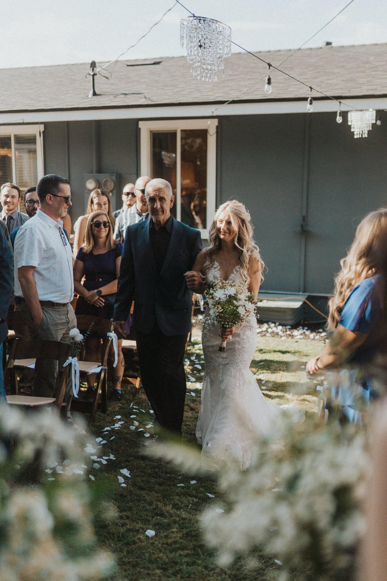 Lexy walks down the aisle on her dad's arm