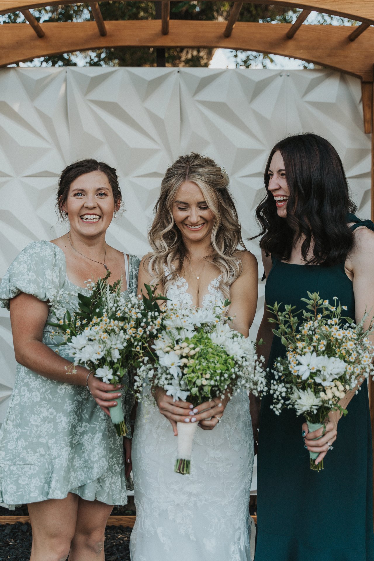 Lexy laughing with her two bridesmaids
