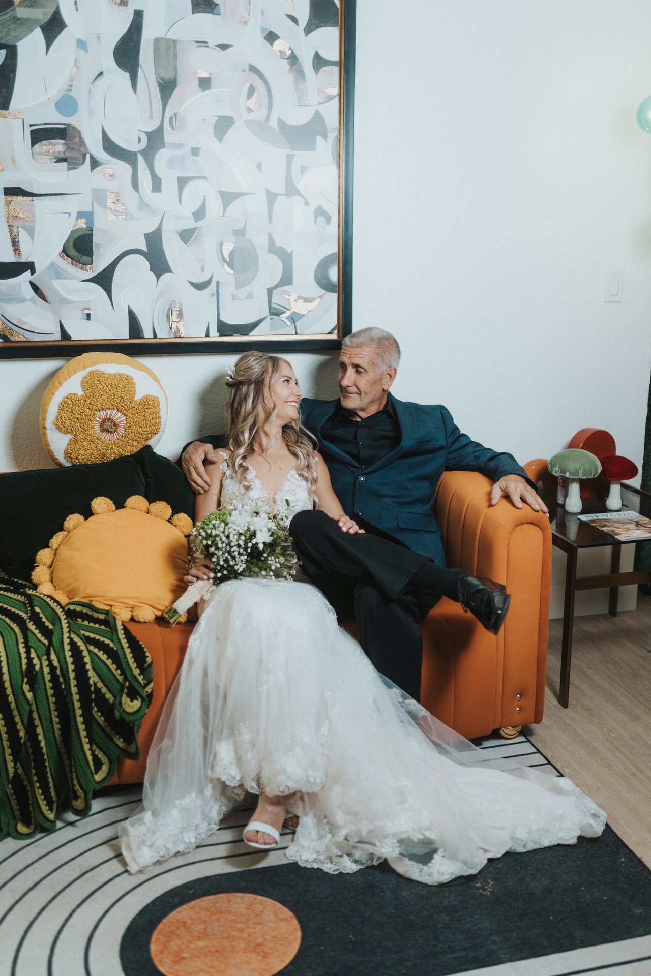 Lexy and her dad together on the orange couch