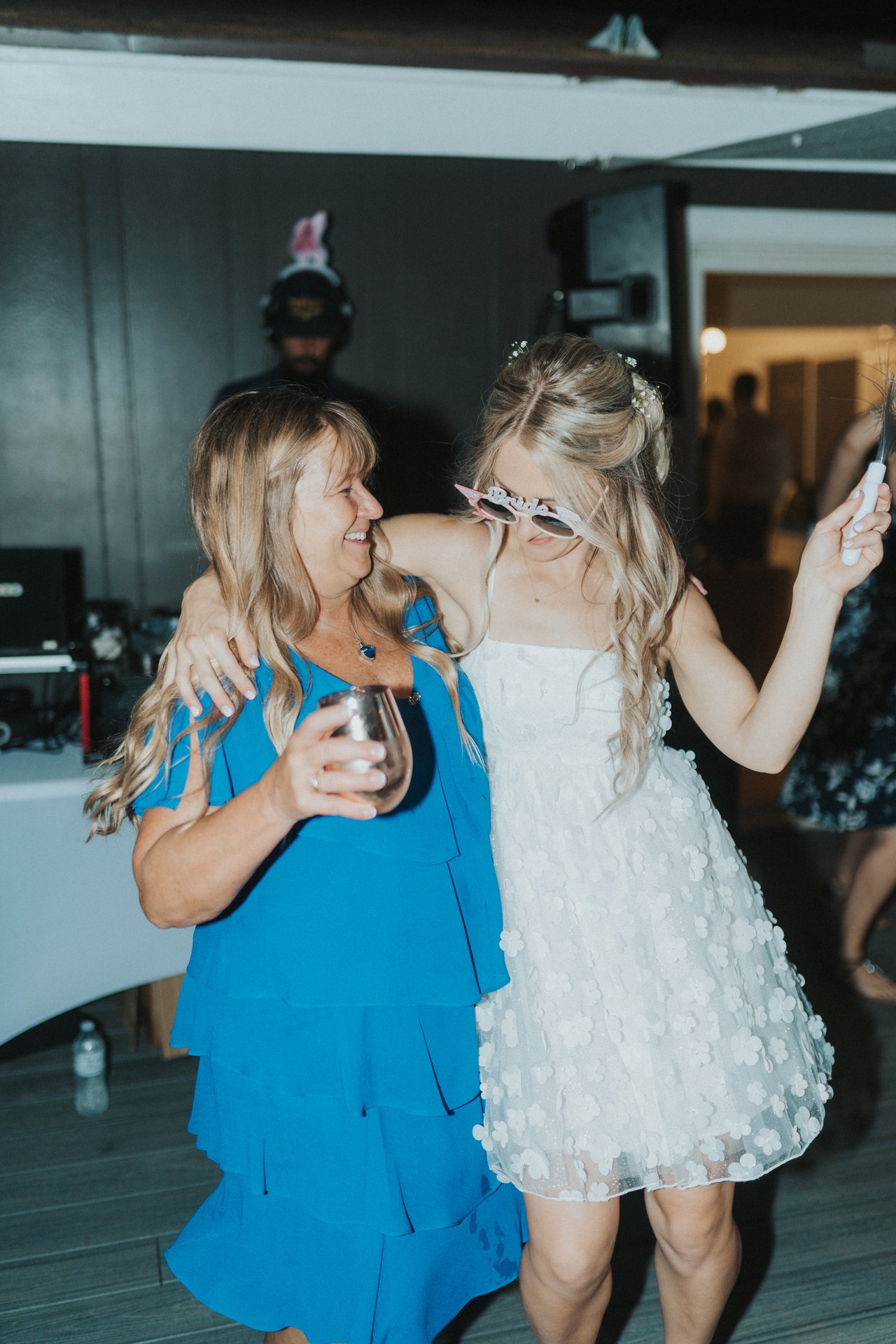 Lexy dancing with a guest in a blue dress