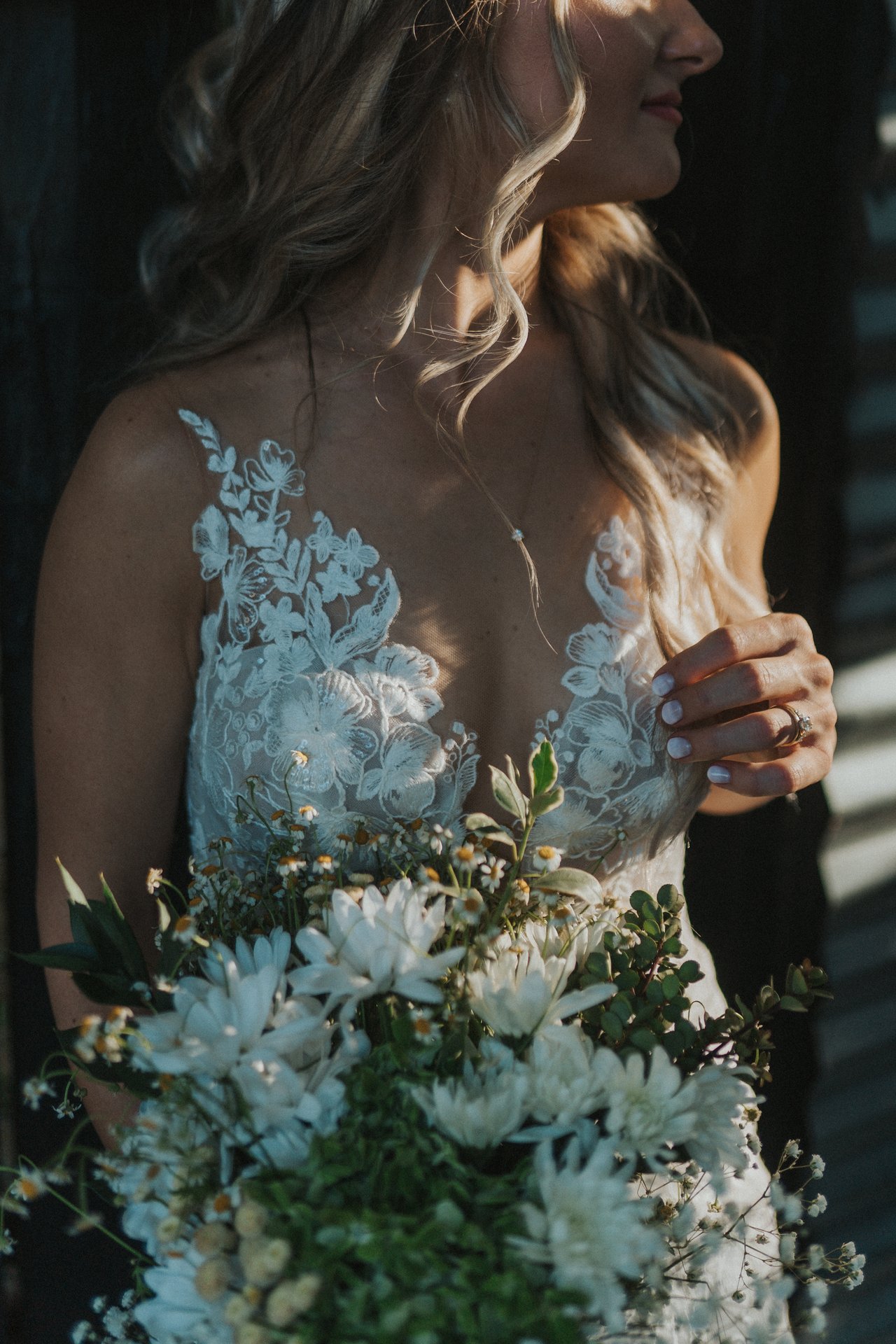 Lexy holding her bouquet in soft shade