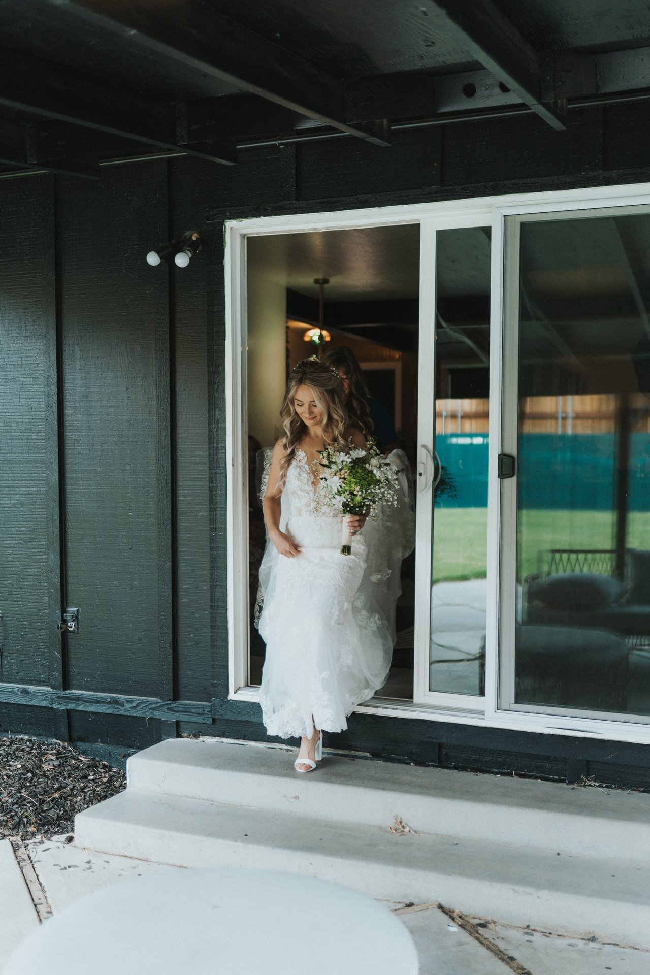Lexy steps out of the house in her wedding dress