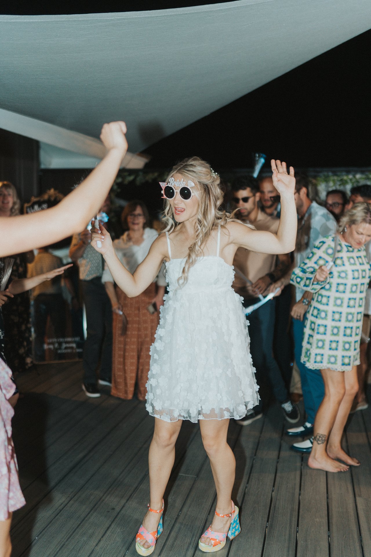Lexy dancing in the crowd in white sunglasses