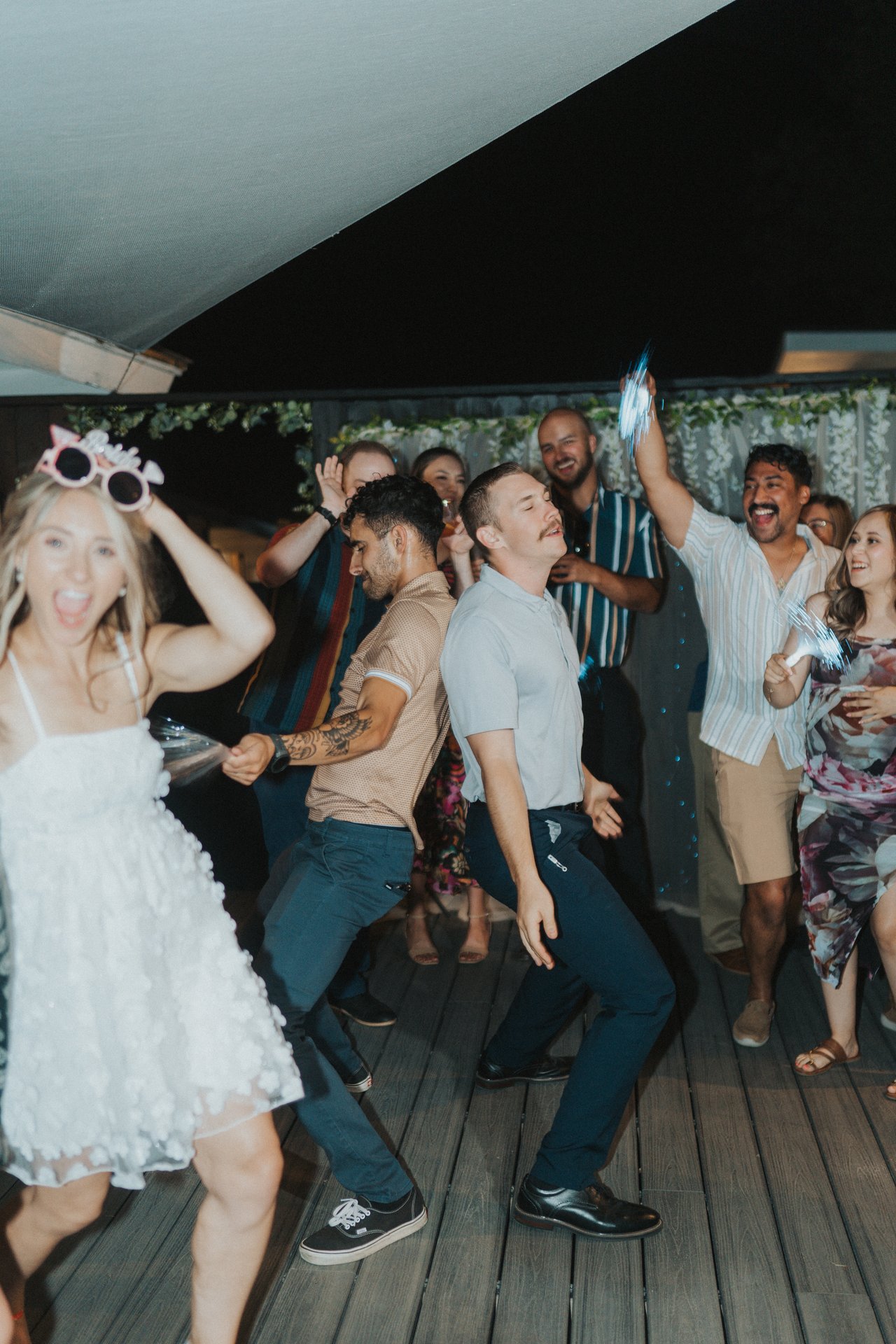 Lexy dancing next to the groomsmen