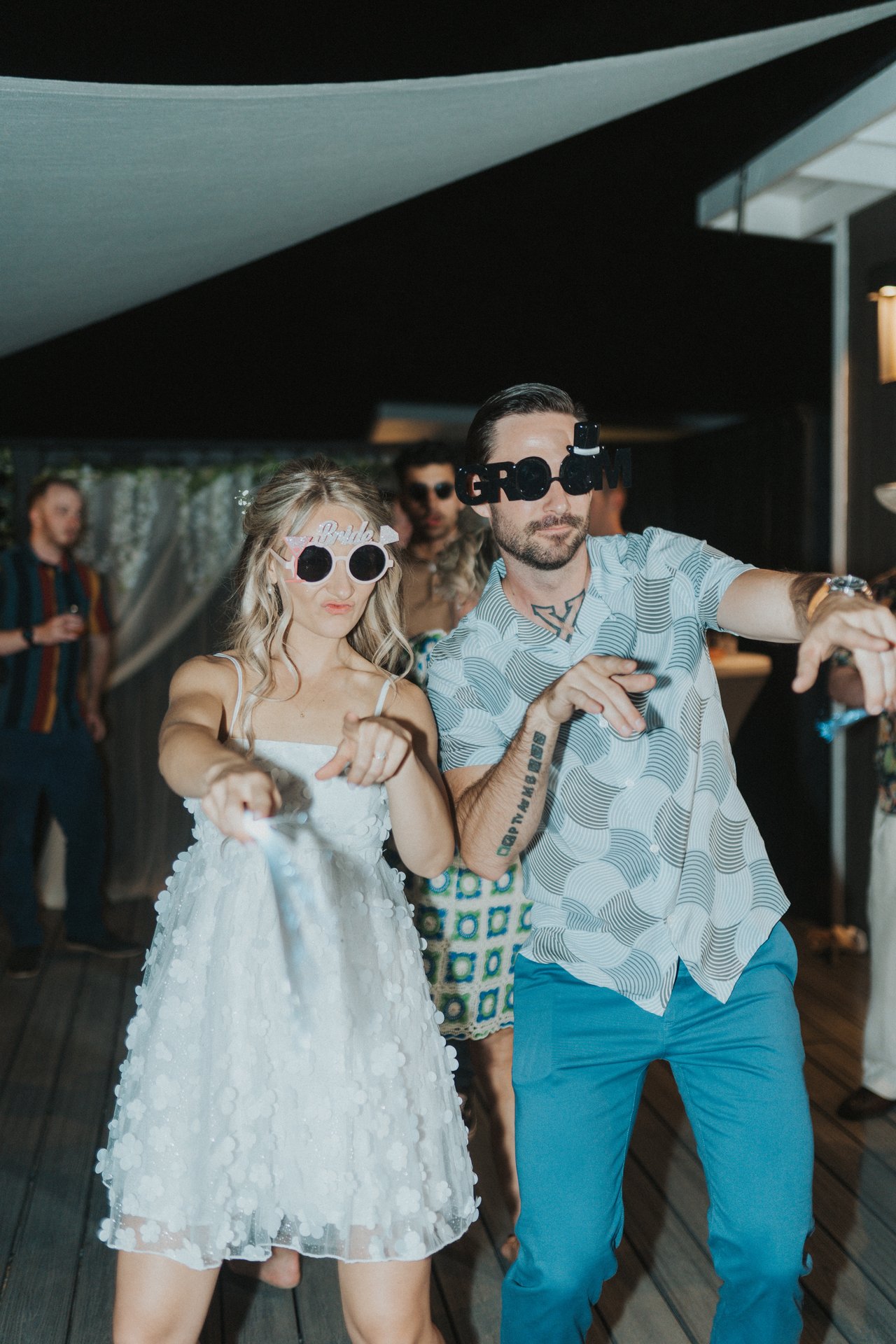 Lexy and Jeremy dance in their novelty sunglasses