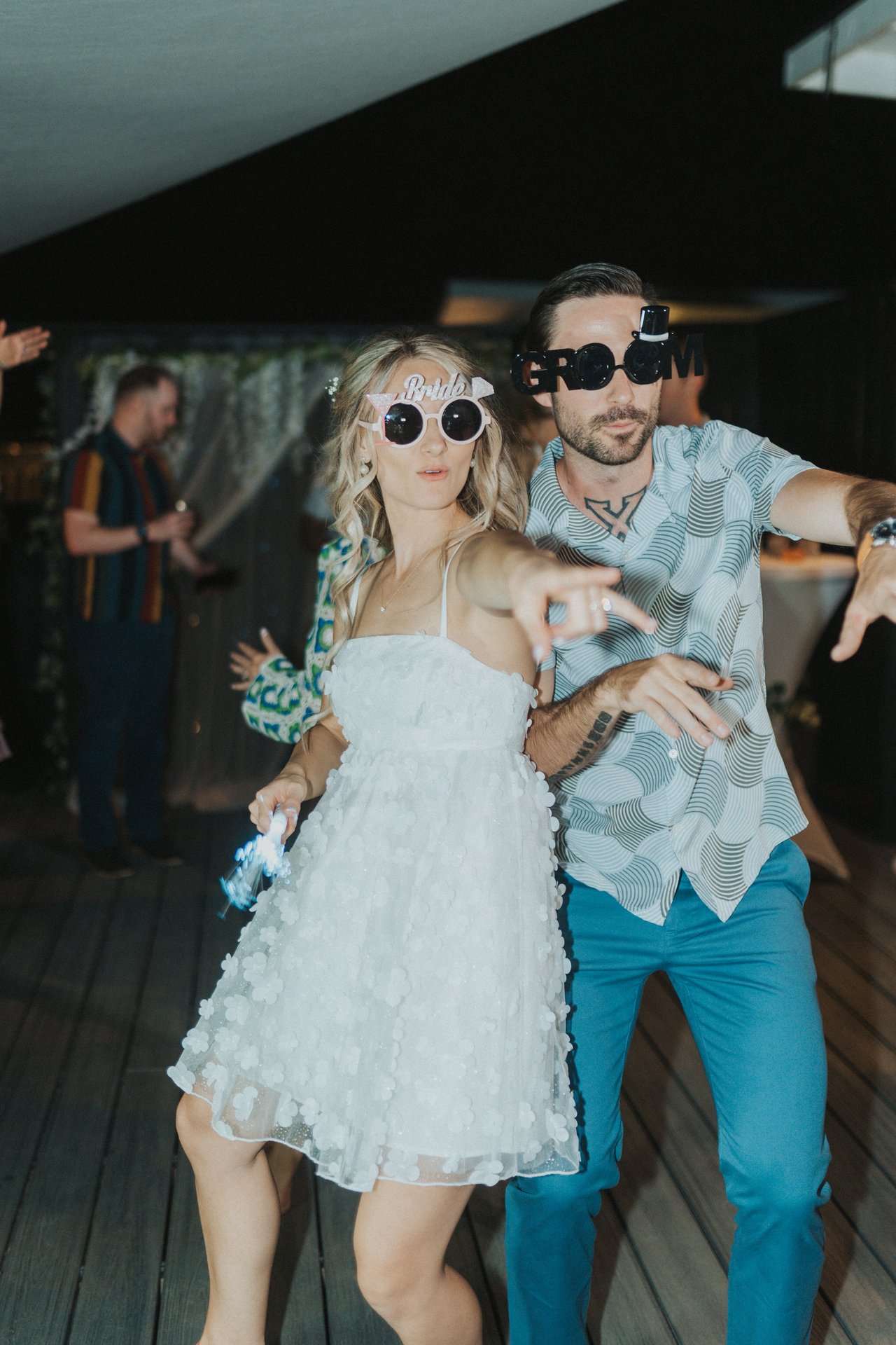 Lexy and Jeremy laughing in novelty sunglasses