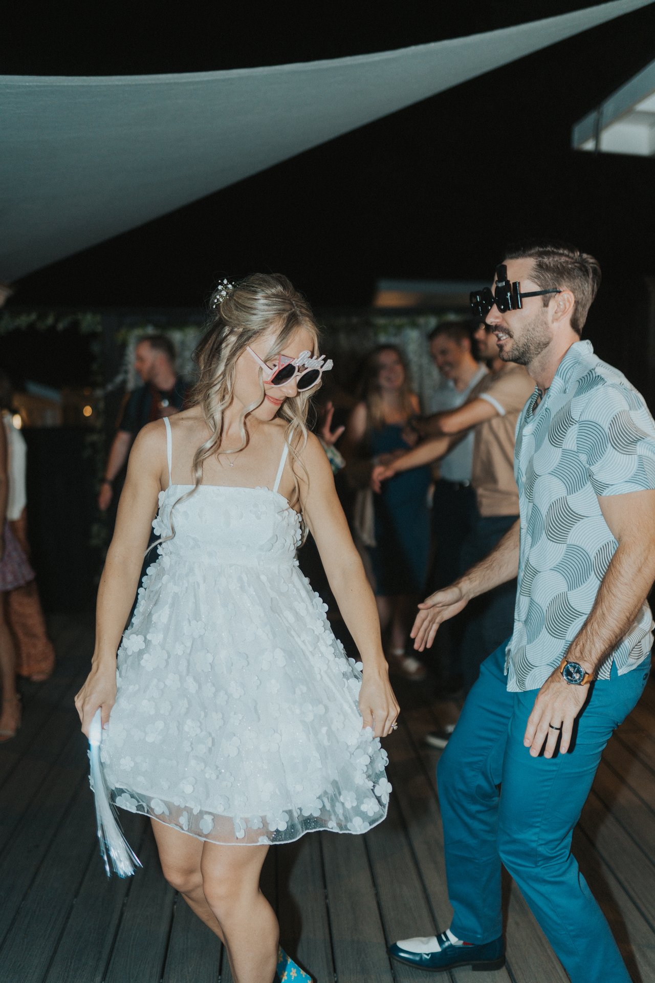 Lexy and Jeremy dancing close in novelty sunglasses