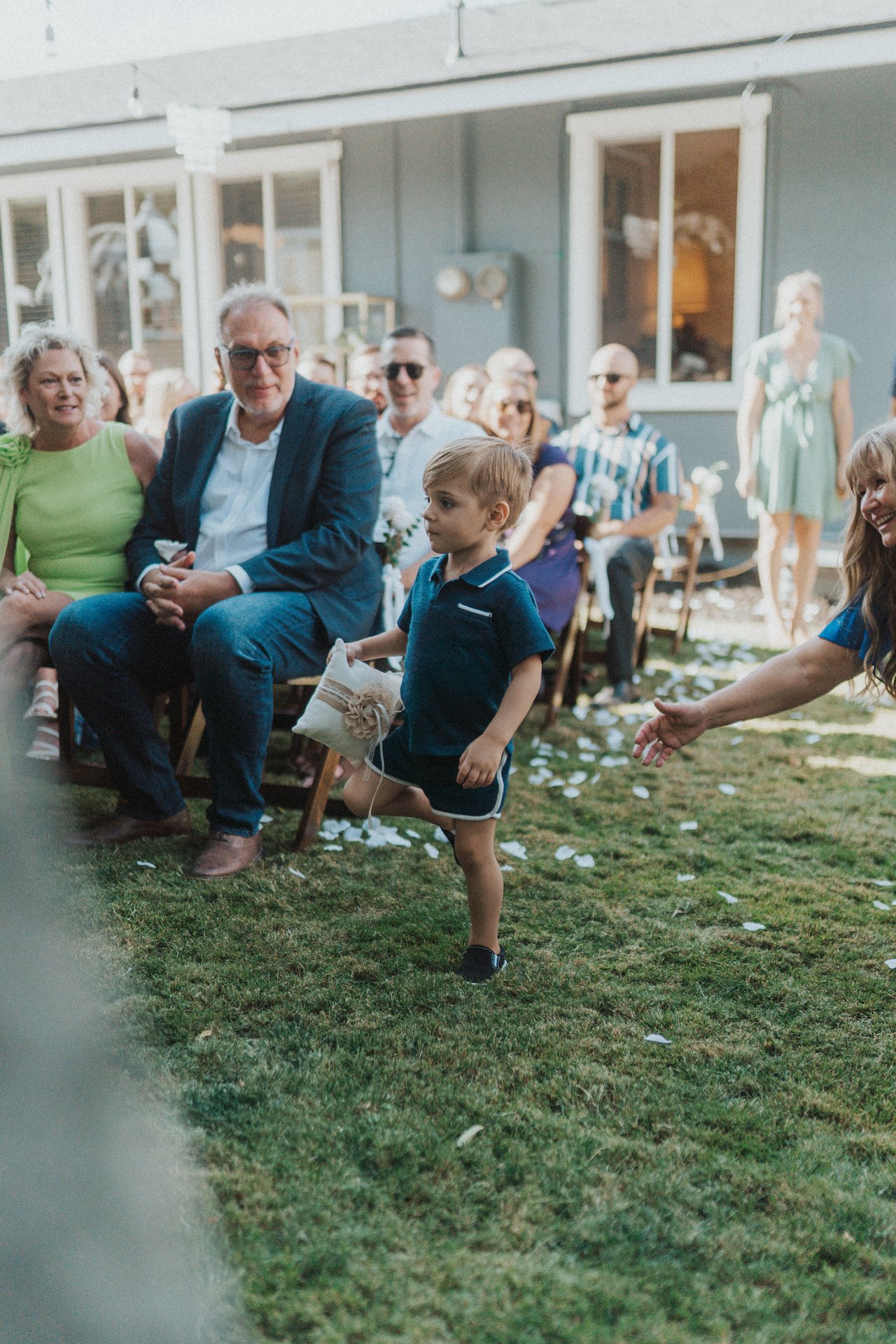 The ring bearer runs down the aisle