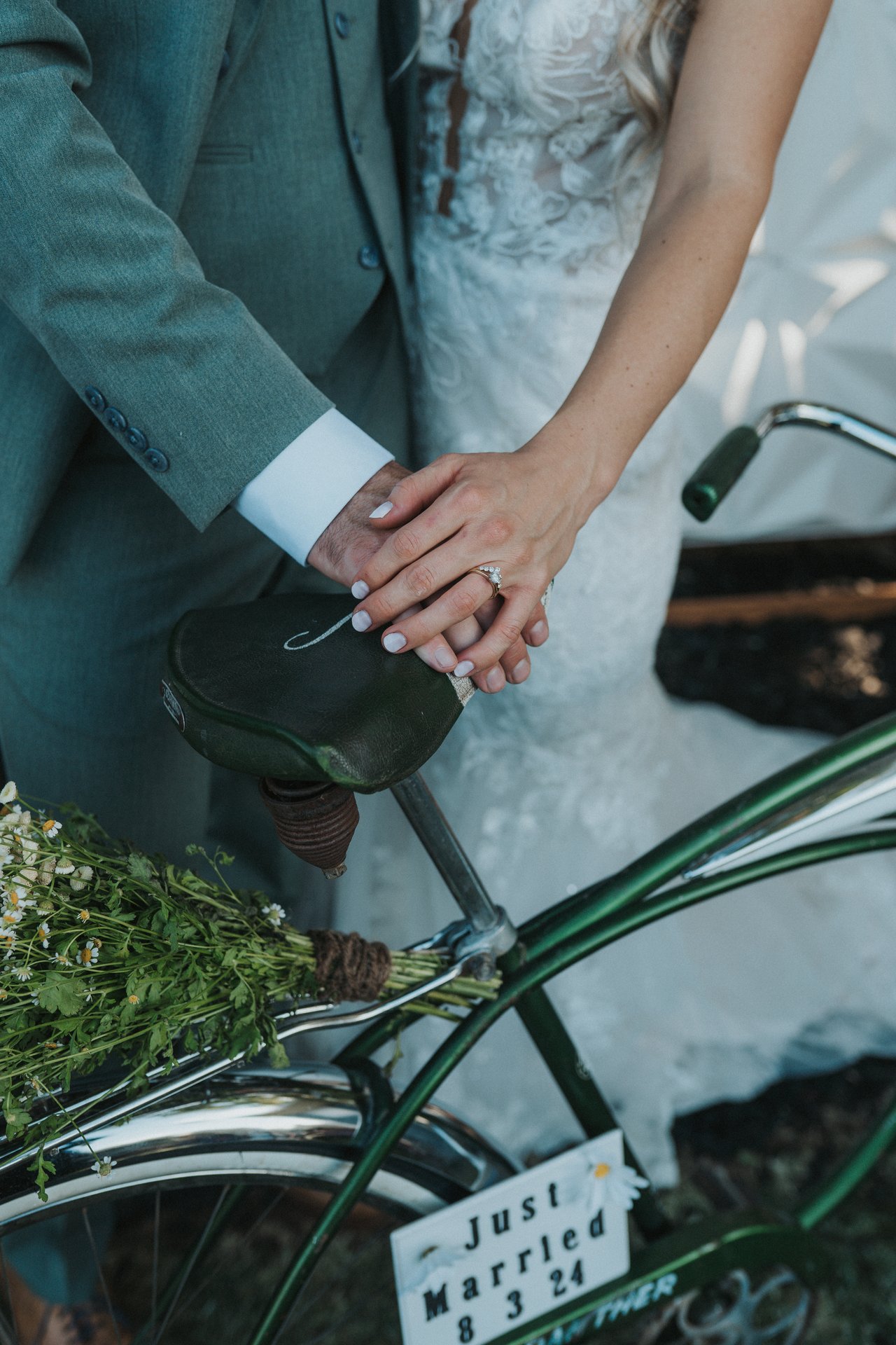 Lexy and Jeremy's hands and rings on the bike handlebars