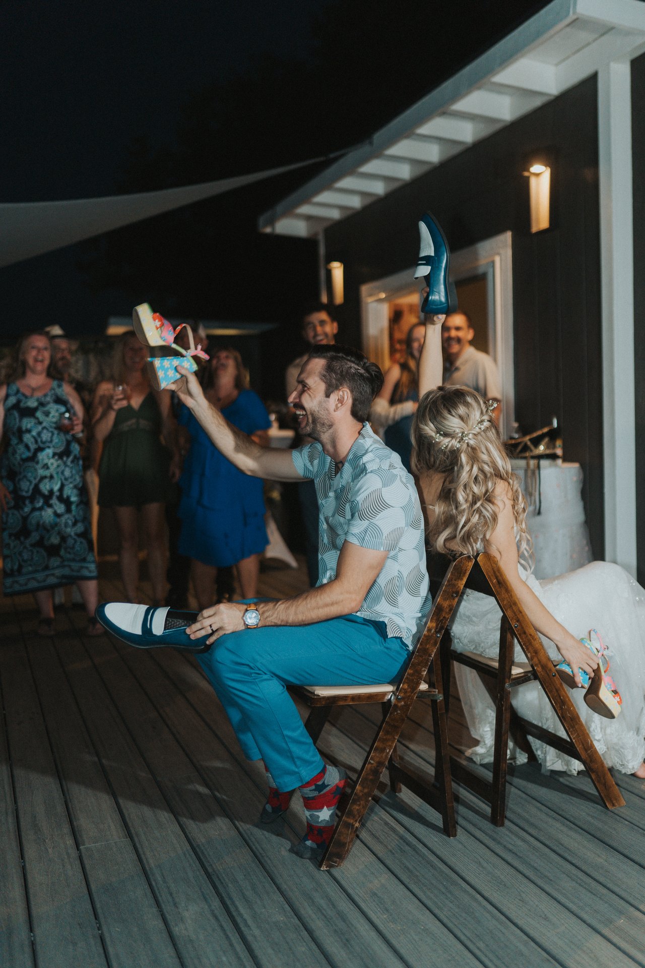 Jeremy laughs as he holds up a shoe