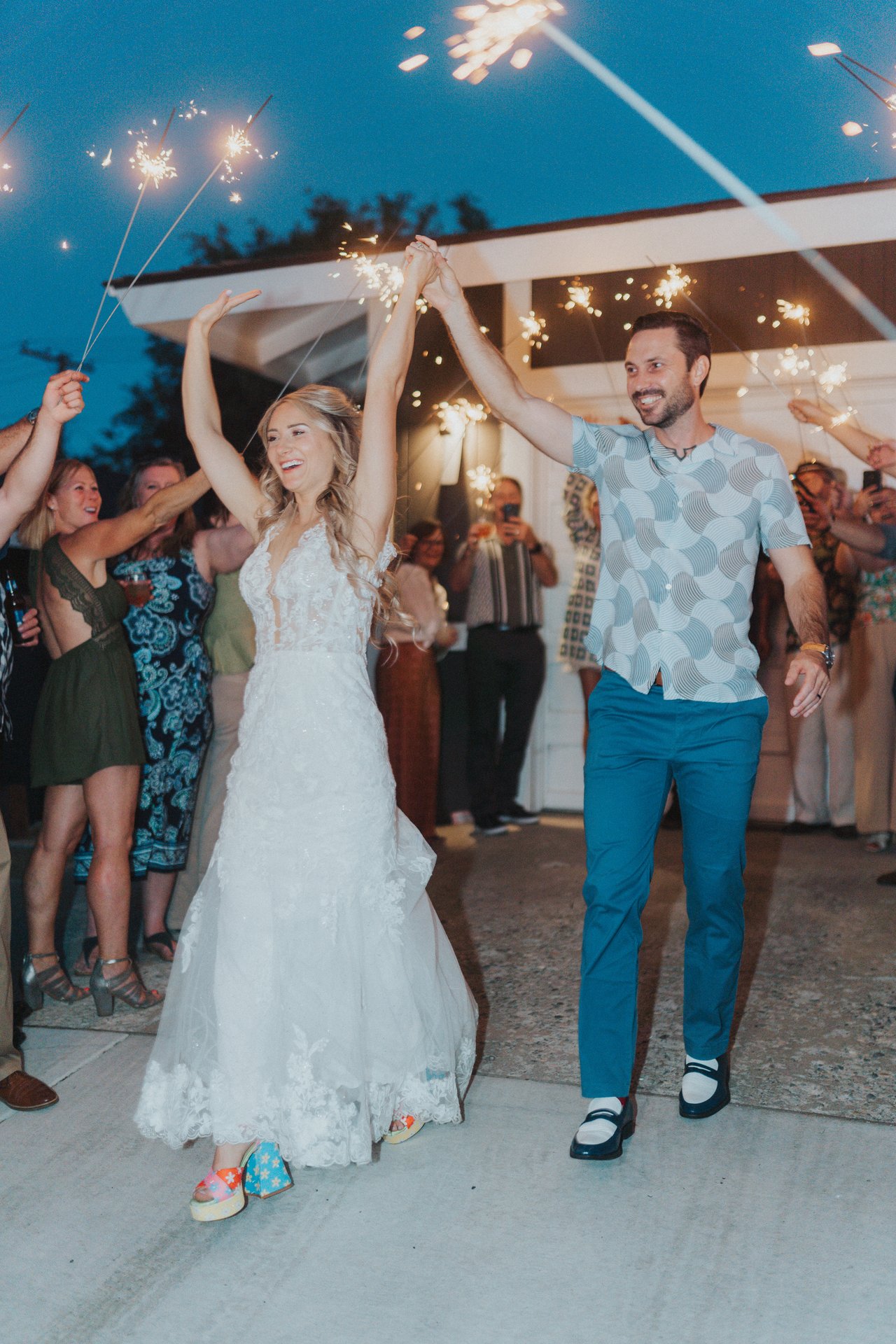 Guests hold sparklers high as Lexy and Jeremy pass through