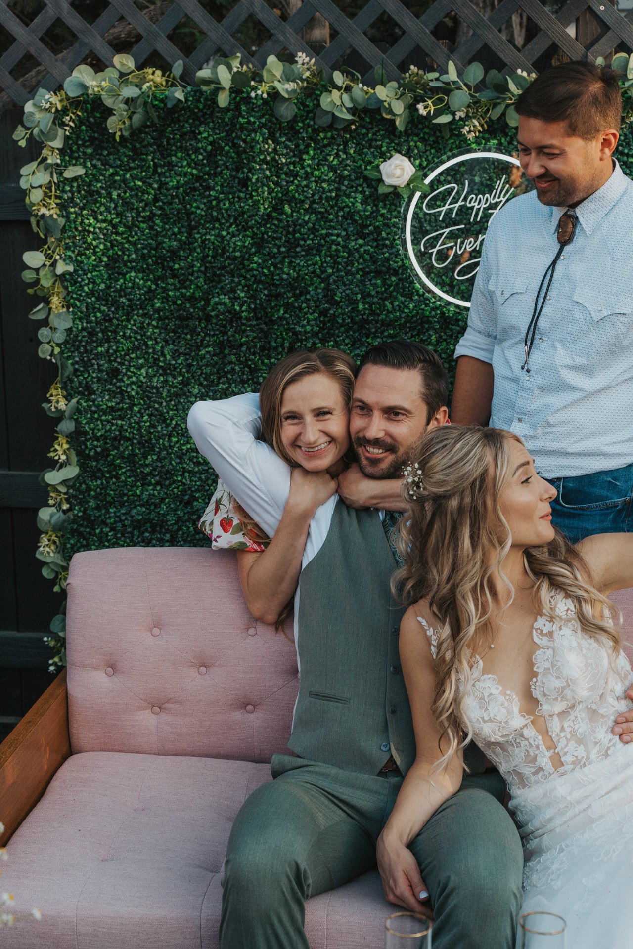 A friend hugs Jeremy from behind the couch
