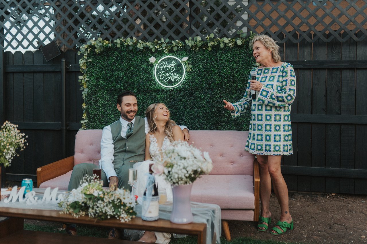 A guest gives a toast beside the couch