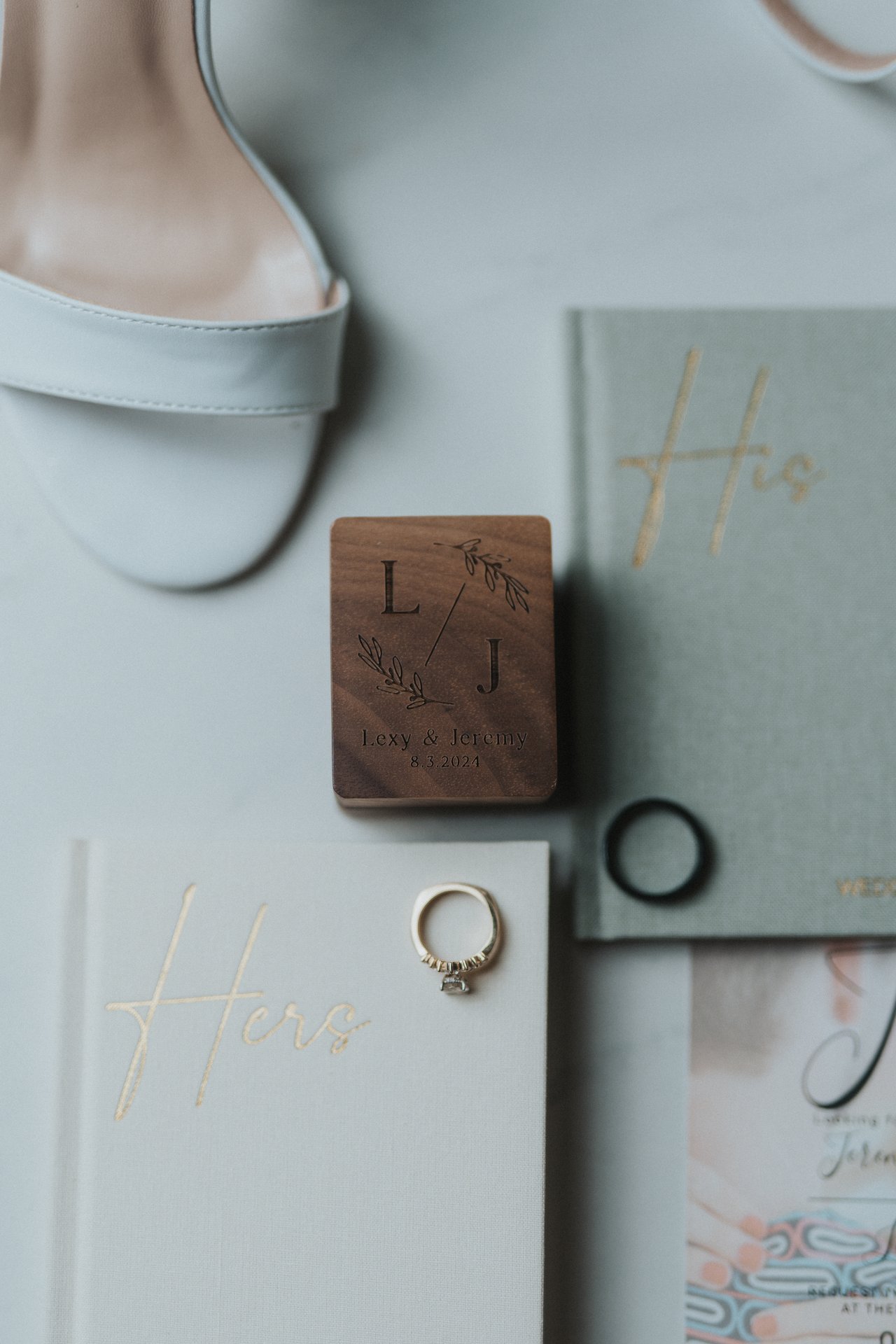 Their vow books and rings laid out with her sandals