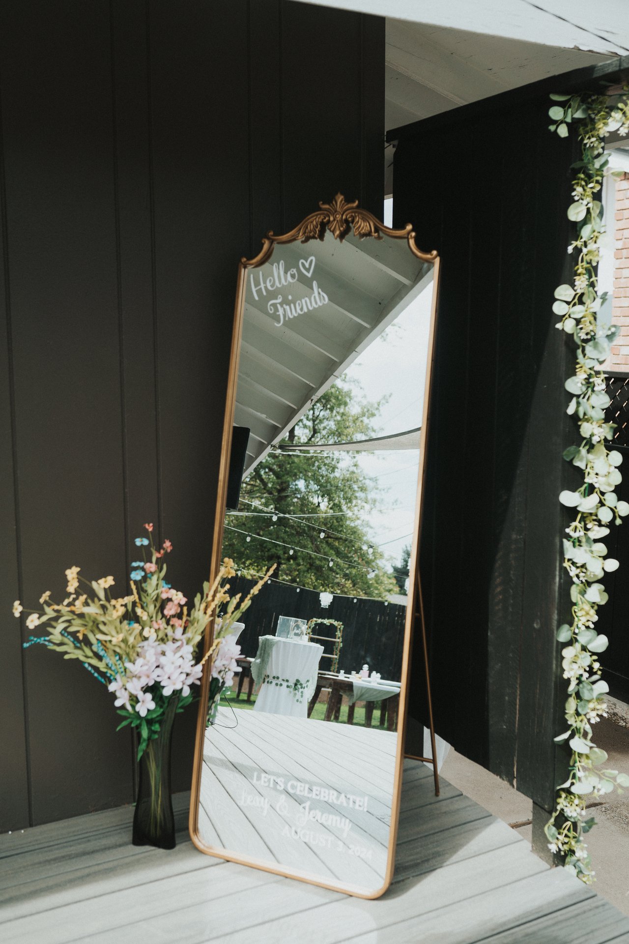 A gold mirror welcome sign on the back patio