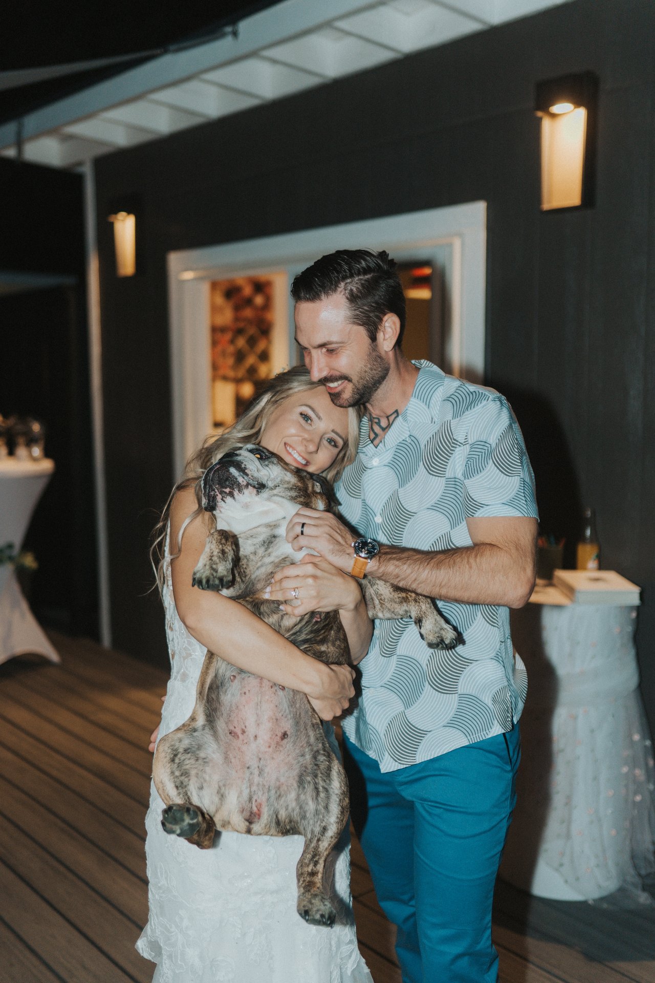 Lexy and Jeremy laughing with their bulldog