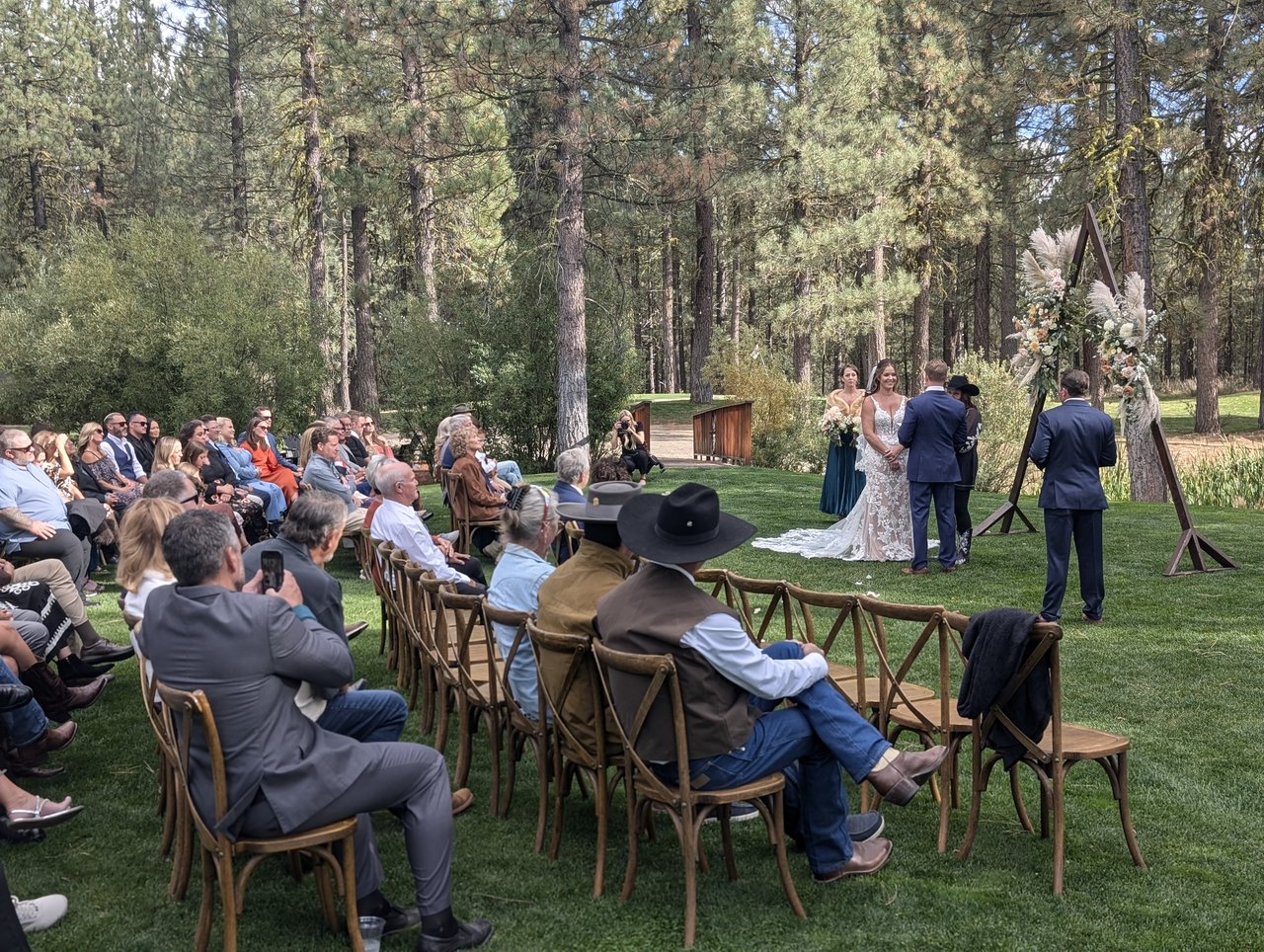 Molly and Matt's ceremony in the pines at Chalet View Lodge, guests seated on the lawn