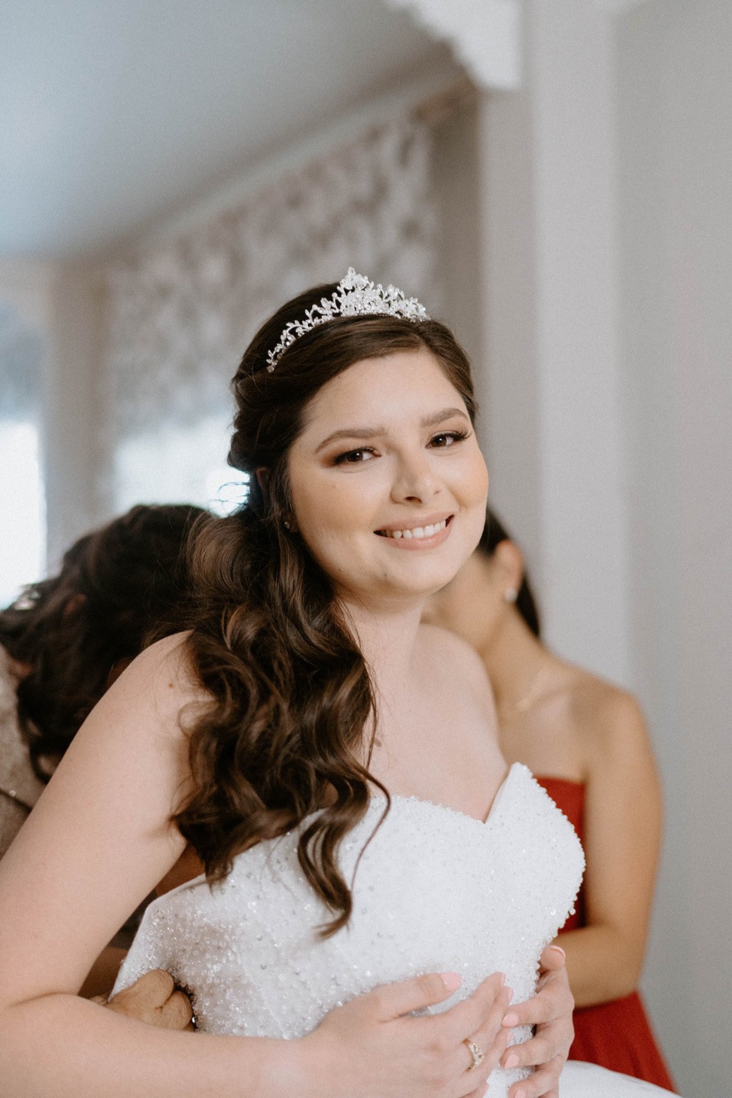 Montse smiles in her tiara and gown as she gets ready