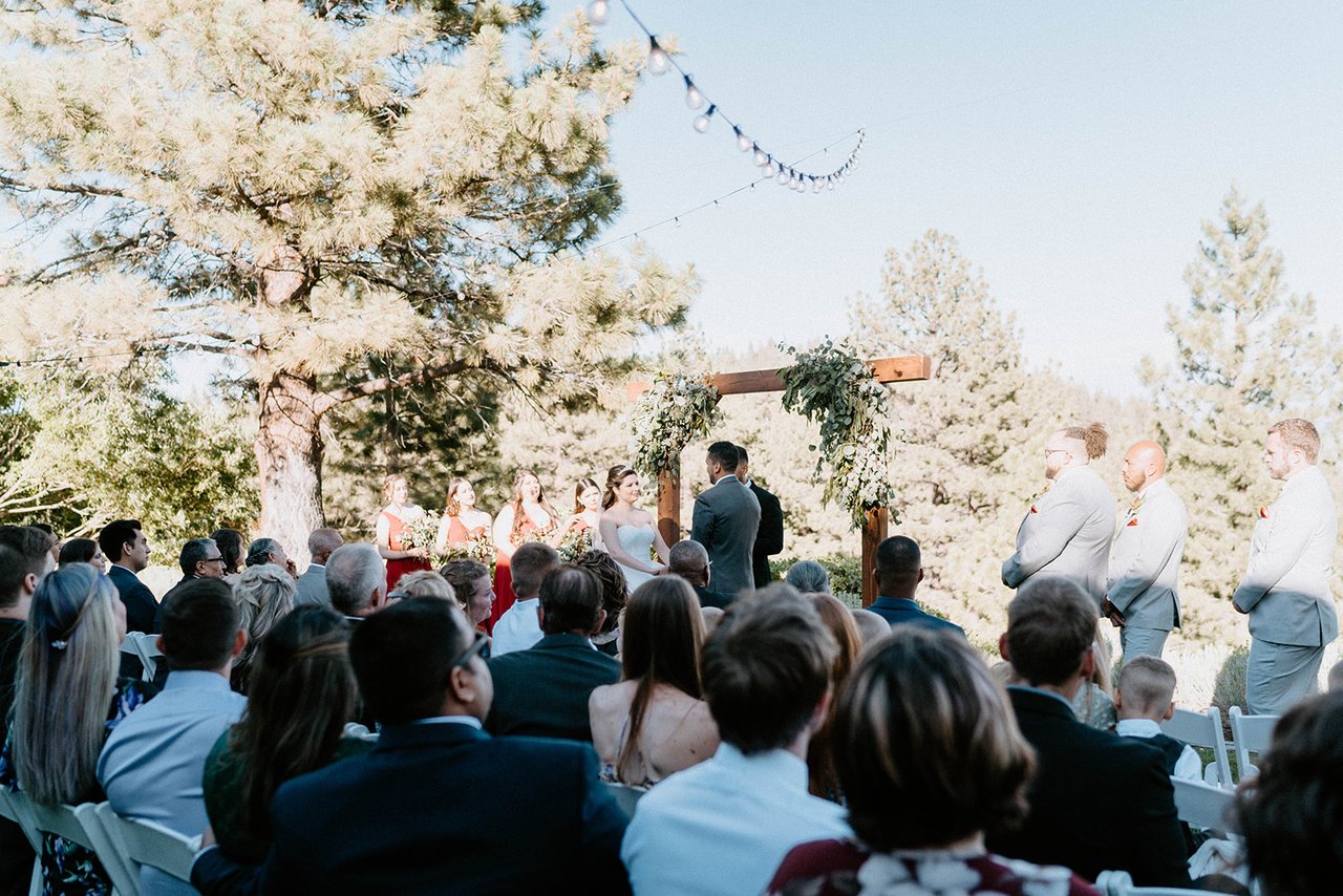 Guests watch the ceremony on the lawn with the valley beyond