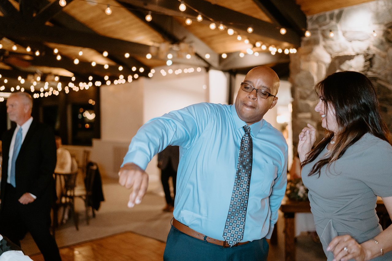 Guests dance under the string lights