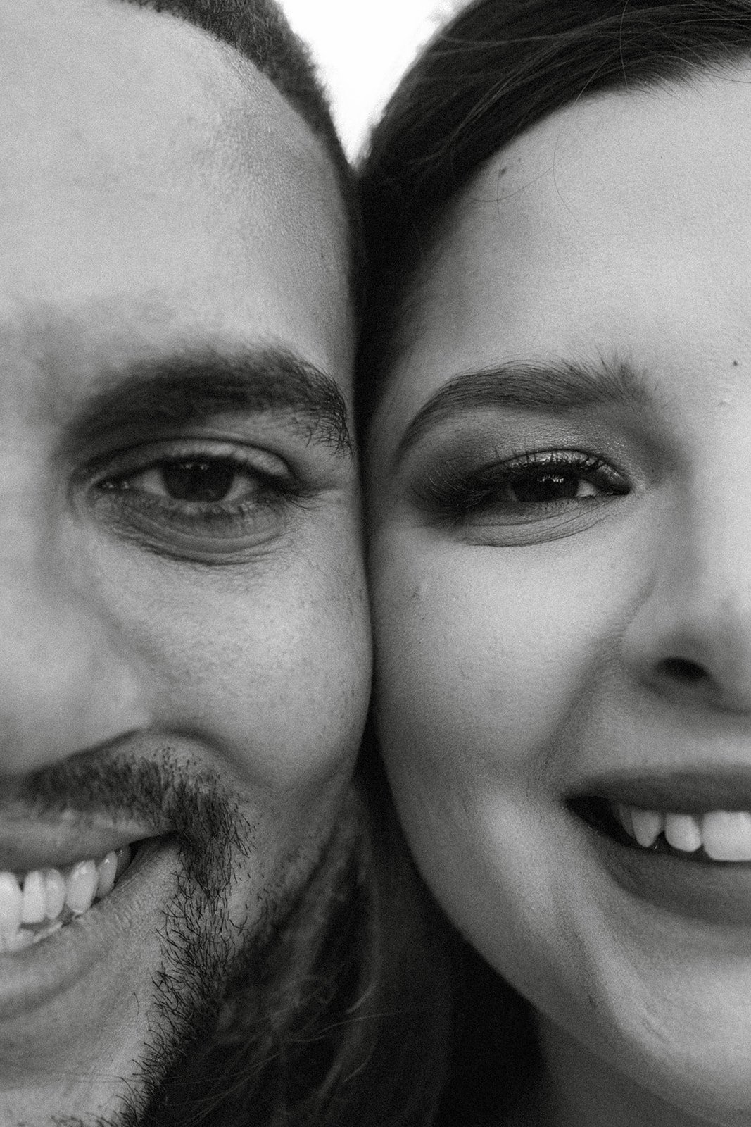 Montse and Jason cheek to cheek, smiling, in black and white