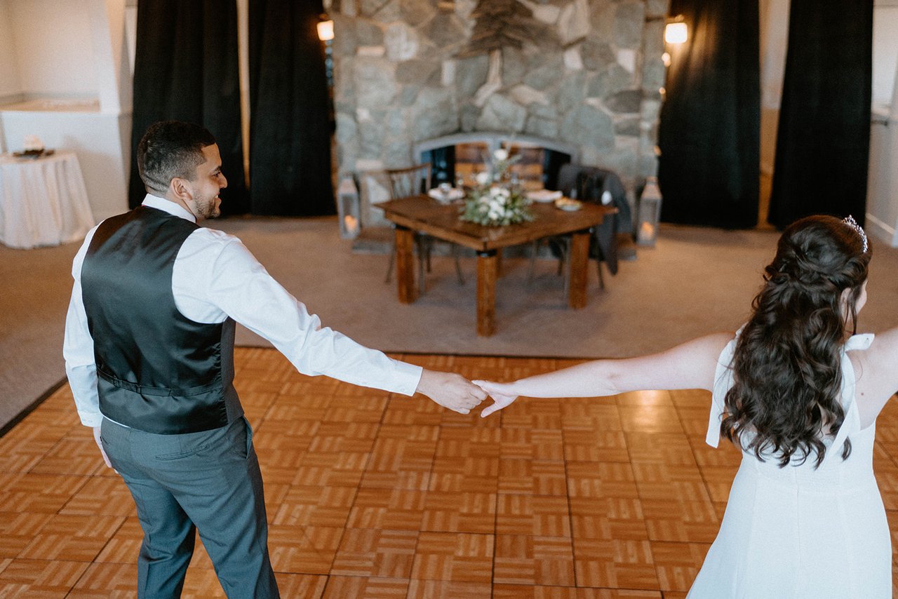 Montse and Jason reach for each other as their first dance begins