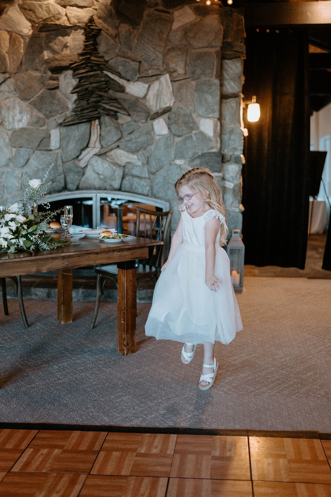 The flower girl skips into the reception