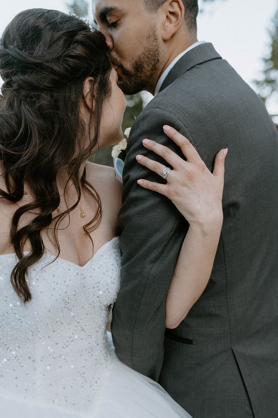 Jason kisses Montse's forehead as she holds his arm