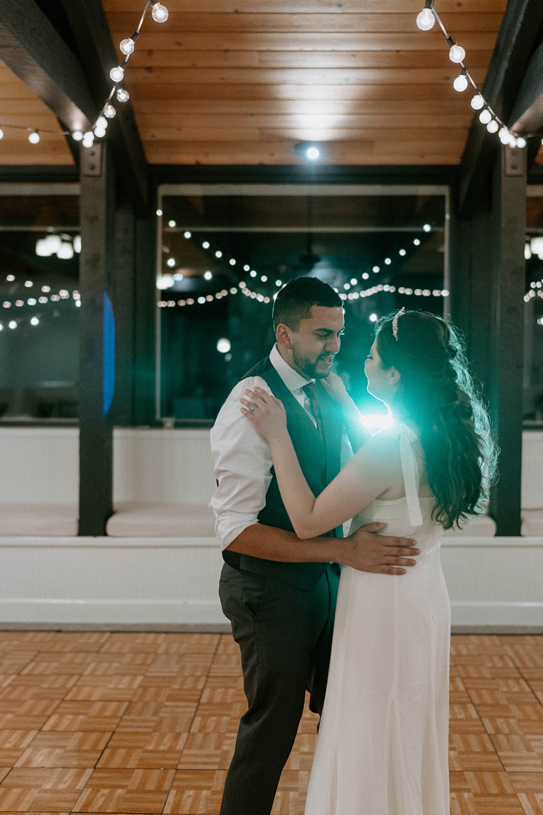 Montse and Jason dance alone under the string lights
