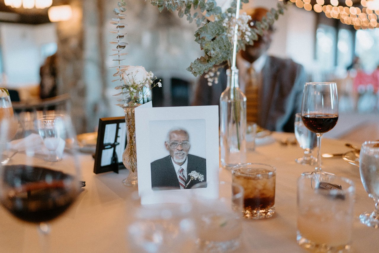 A framed photo of a loved one on a reception table