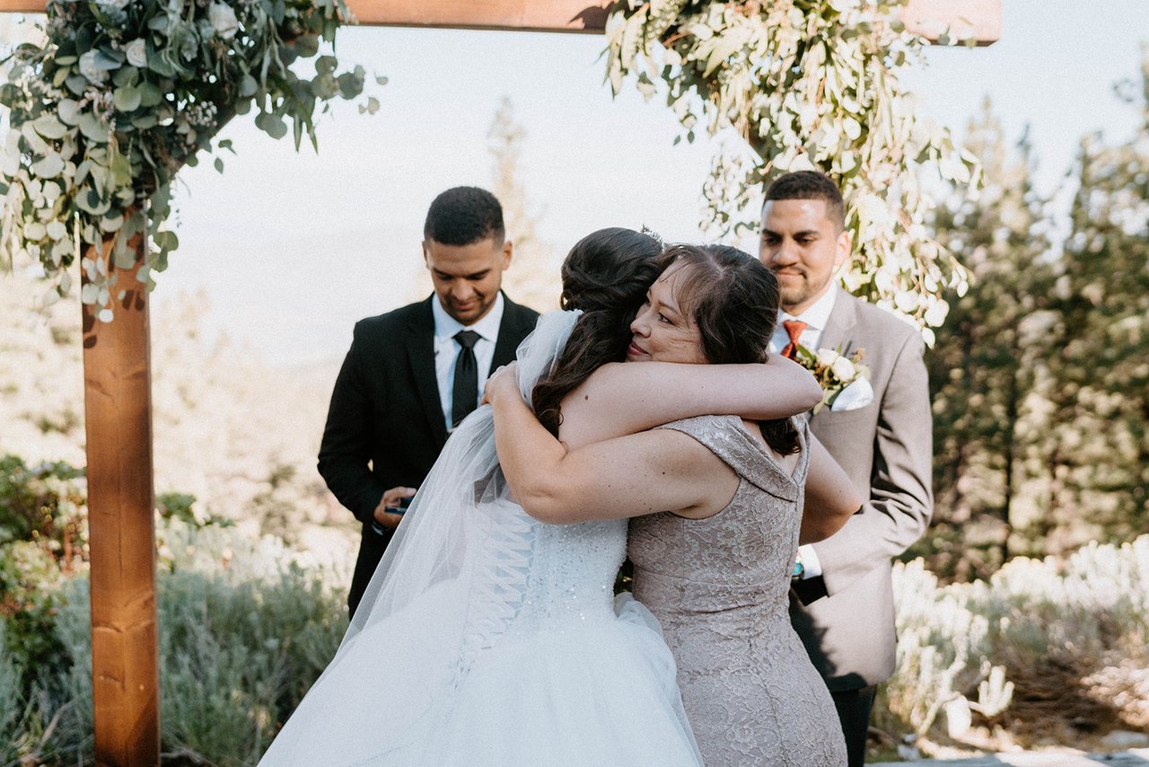 Montse hugs a loved one at the arch