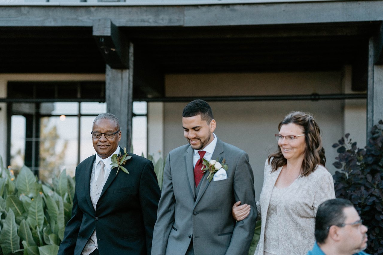 Jason walks down the aisle between his parents