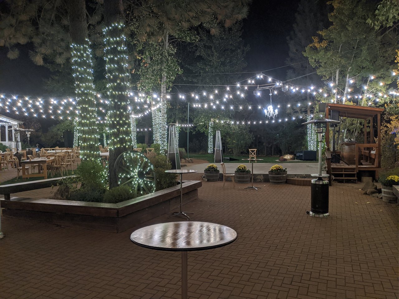 The empty courtyard glowing with tree lights and string lights at the end of the night