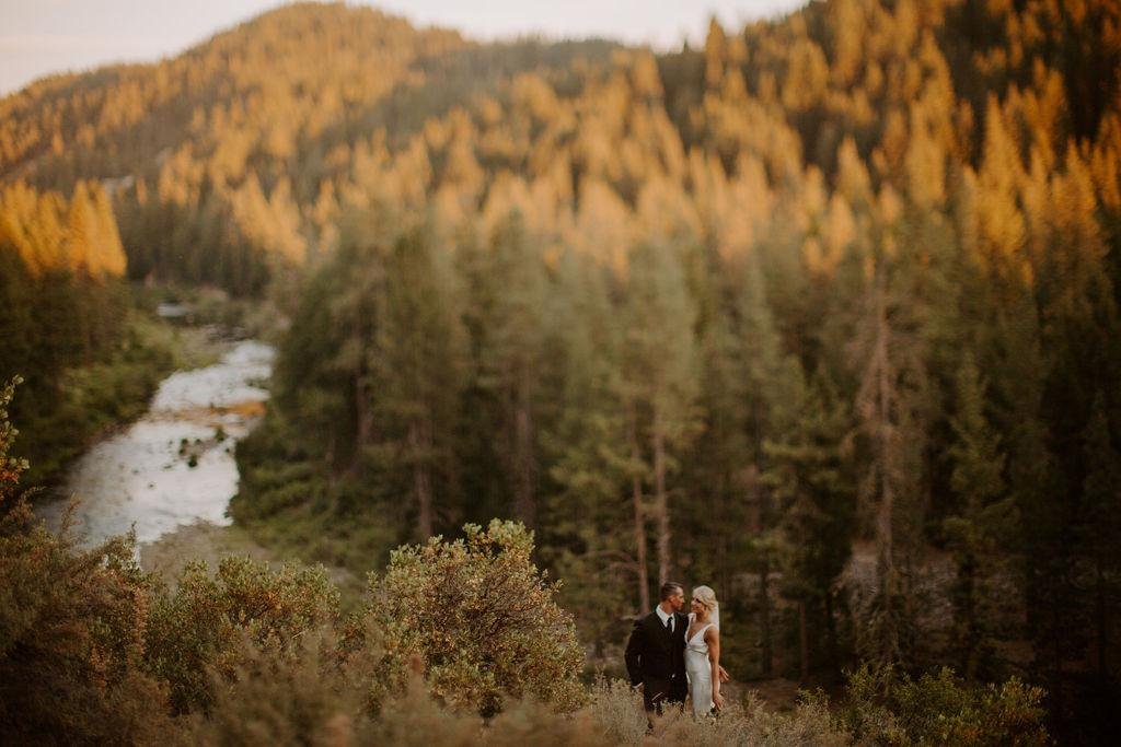 Nicole and Tim above the river valley in the golden evening light, photo by Taylor McCutchan Photography