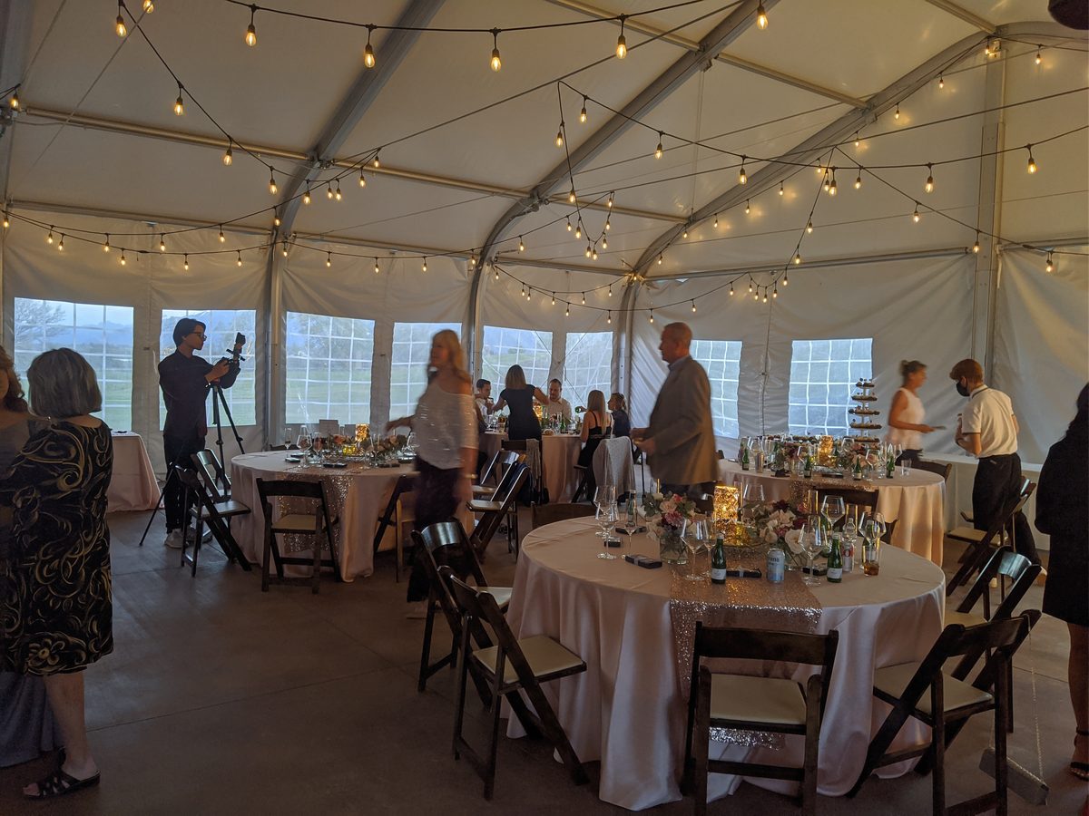 String lights glow over the reception tables at Sunridge Golf and Recreation before the party