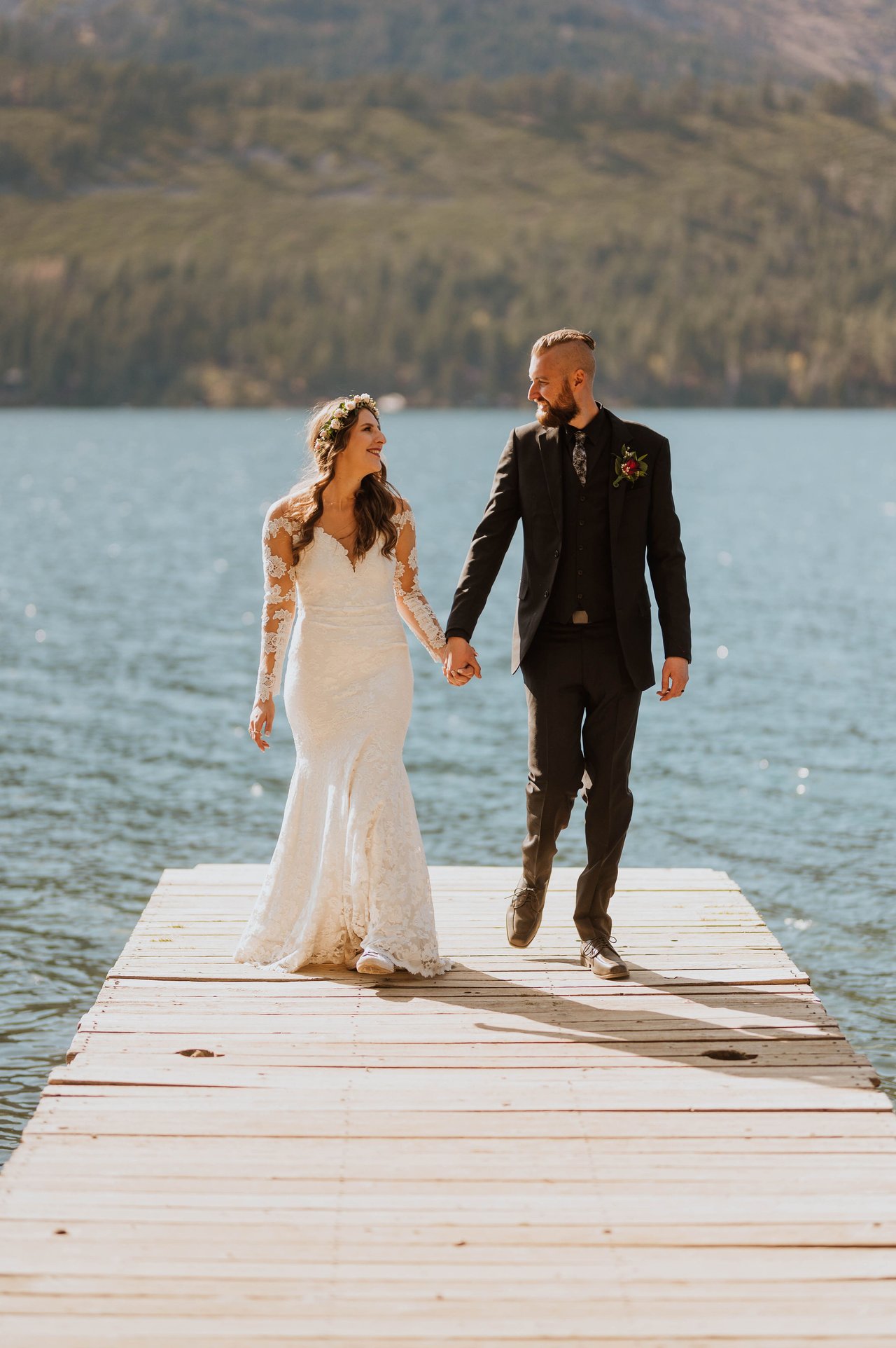 Rachel and Christopher walk hand in hand on the dock