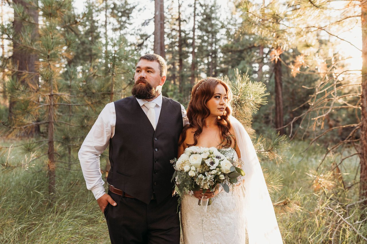 Remy and Tom stand together among the pines at Valhalla