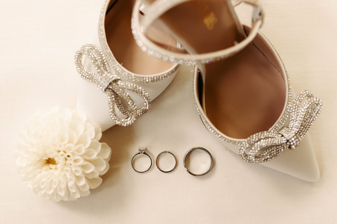 Remy's shoes, the wedding rings and a dahlia laid out before the ceremony