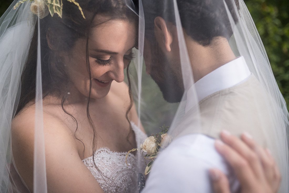 Shannon and Ryan close together under her veil