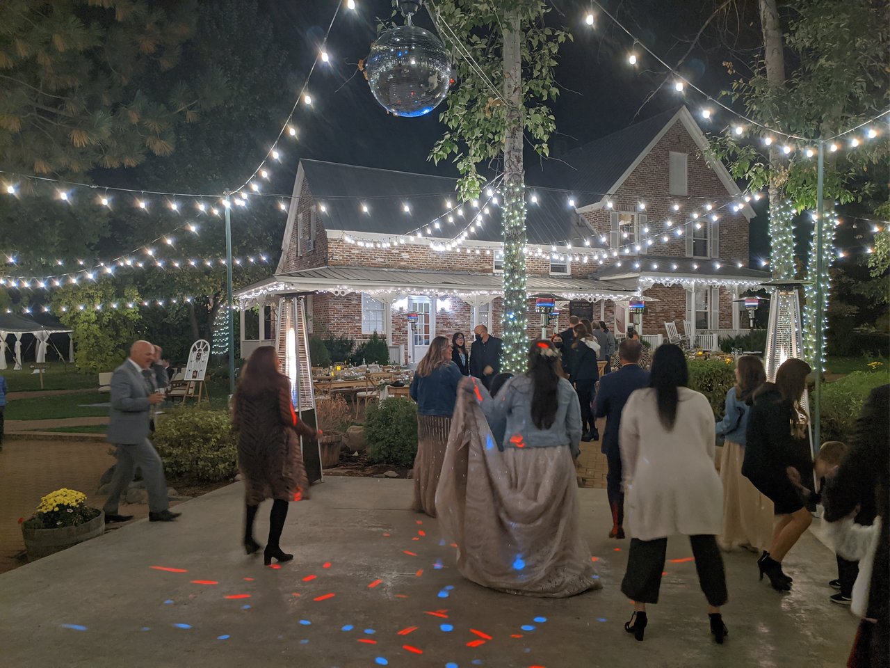 Taylor dances in her gown and denim jacket under the disco ball and string lights