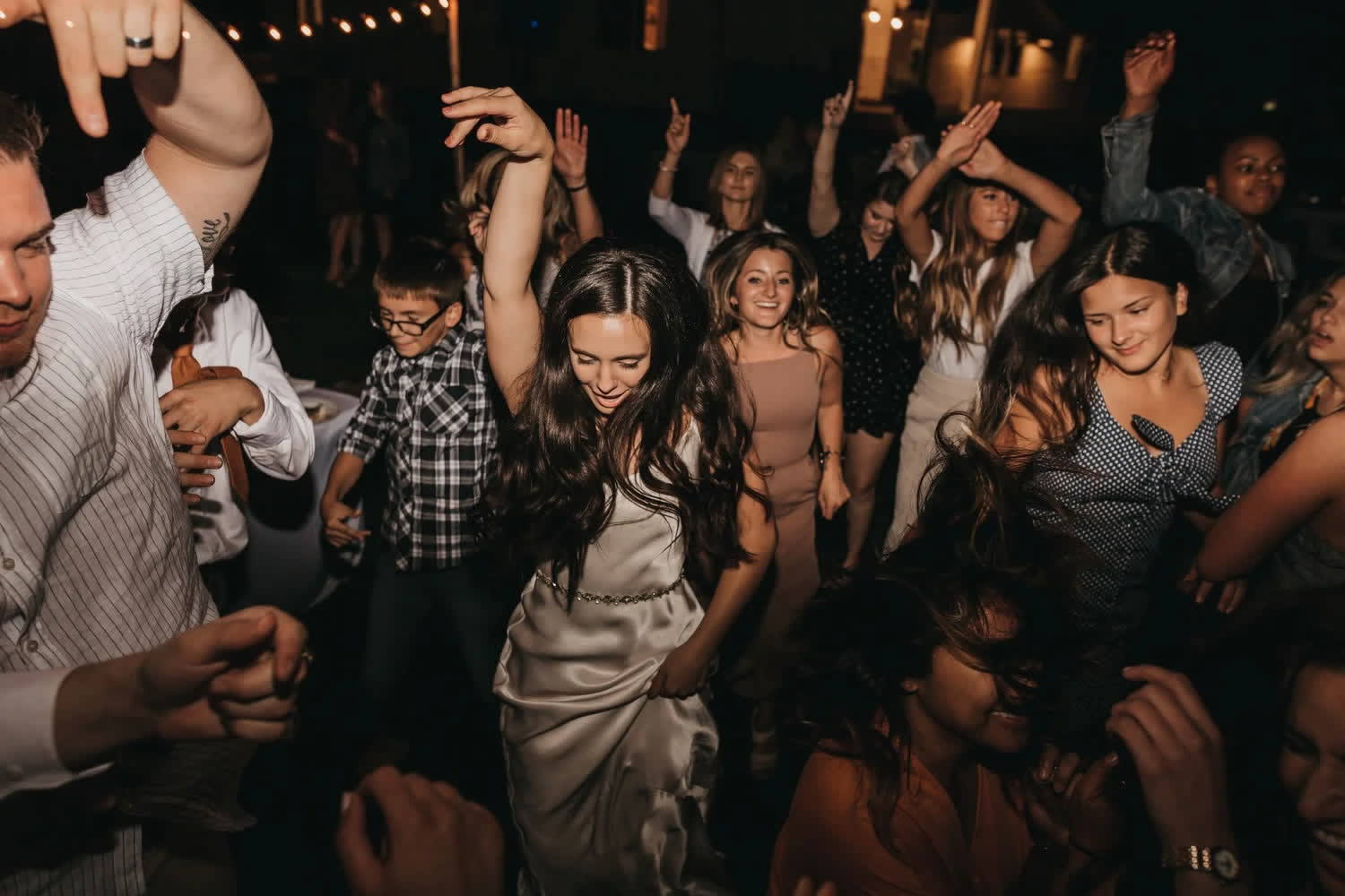 The outdoor dance floor under string lights at a Twenty Mile House wedding in Graeagle